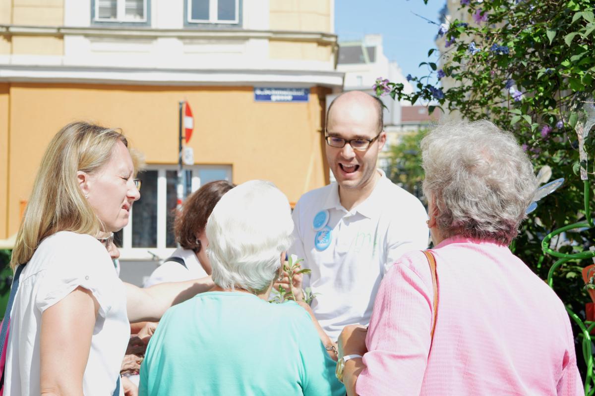 Sreco Dolanc erklärt die Wirkung von Kräutern im Kräuterbeet vor der Marienapotheke